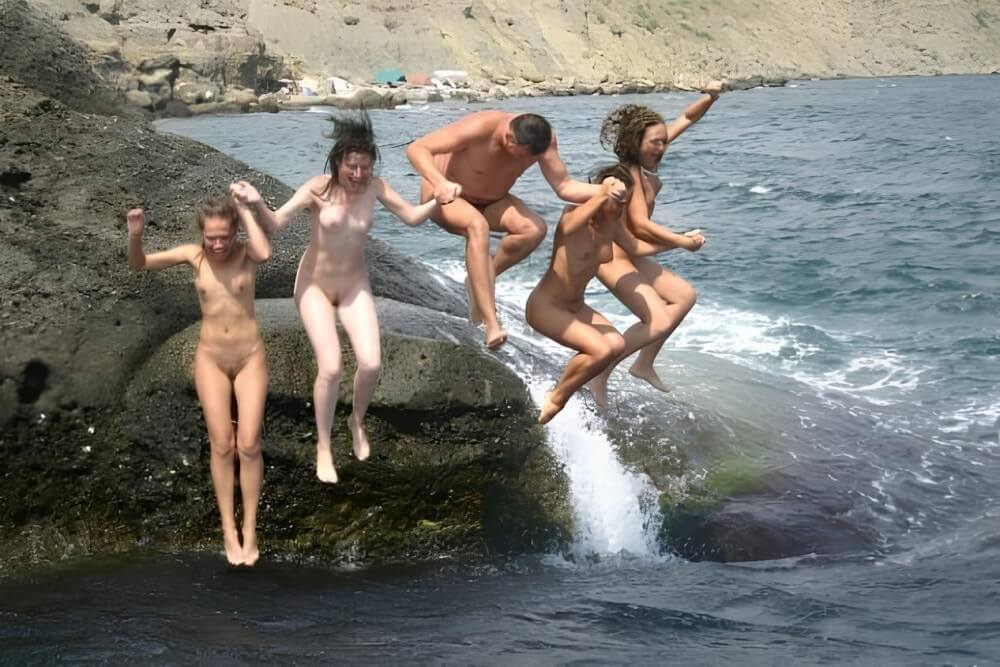 Mens and girls nudists on a beach